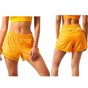 Athleta mustard yellow performance wear athletic printed mesh racer run shorts
